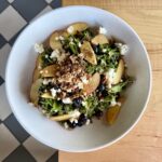 Kale salad with blueberries, peaches, goat cheese, candied pecans, and blueberry vinaigrette.