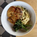 Parmesan crusted chicken breast with tagliatelle, broccolini and Alfredo sauce at Olives Restaurant in East Grand Rapids